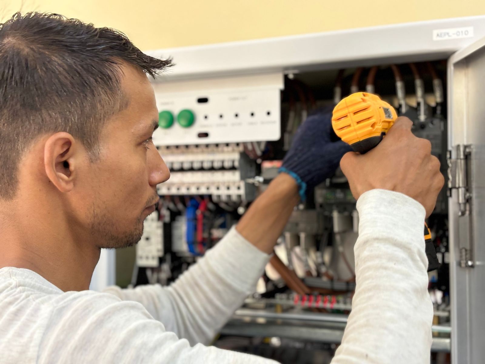 Electrical trainee working on equipment