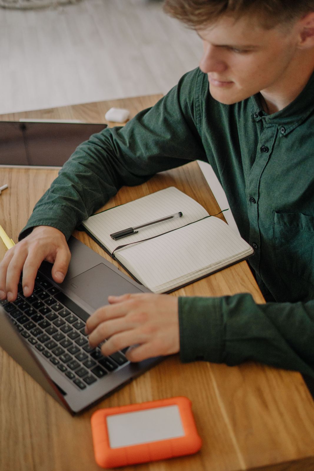 Adult student studying HVAC coursework on a laptop at the kitchen table