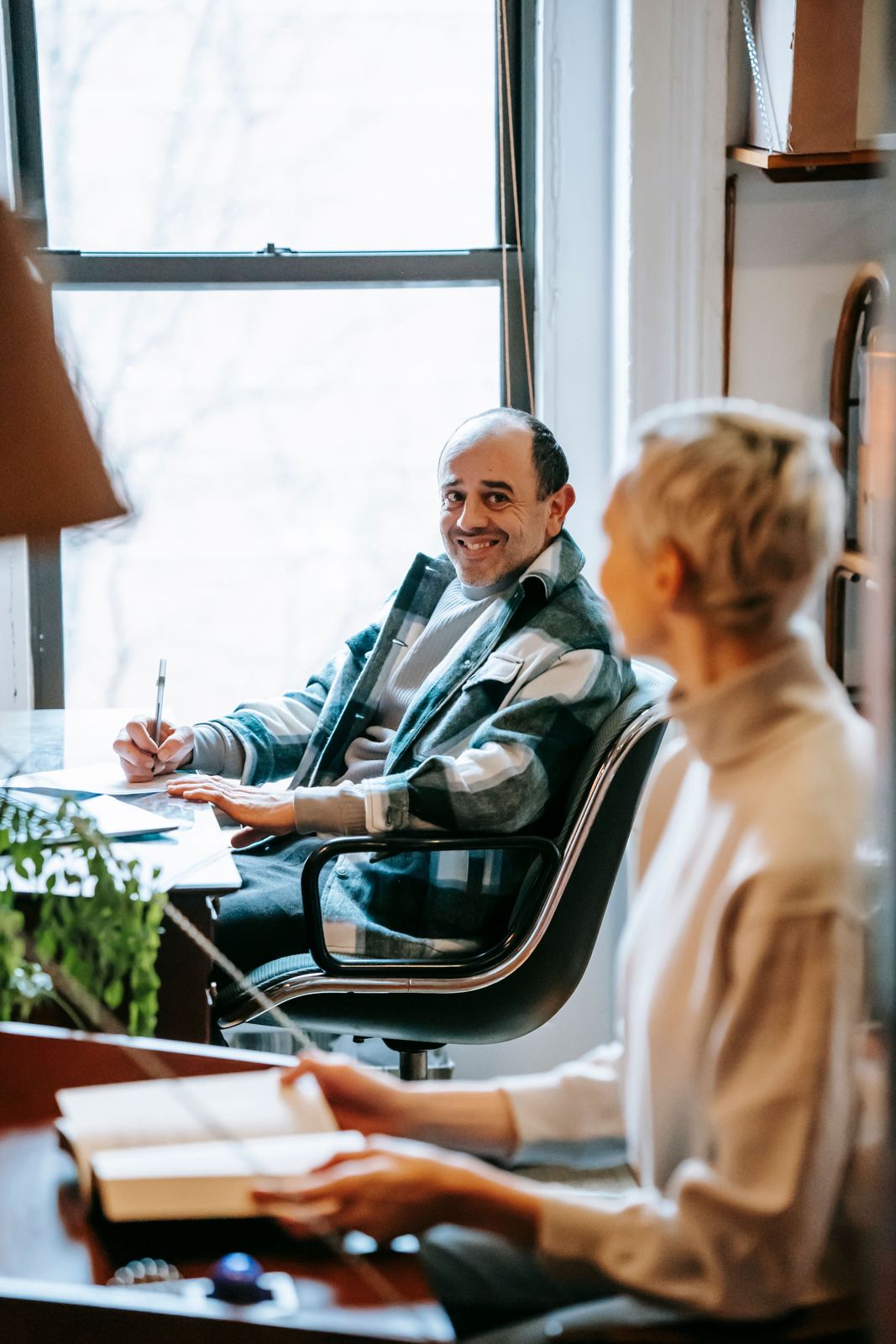 Case manager meeting with an adult job seeker at a table